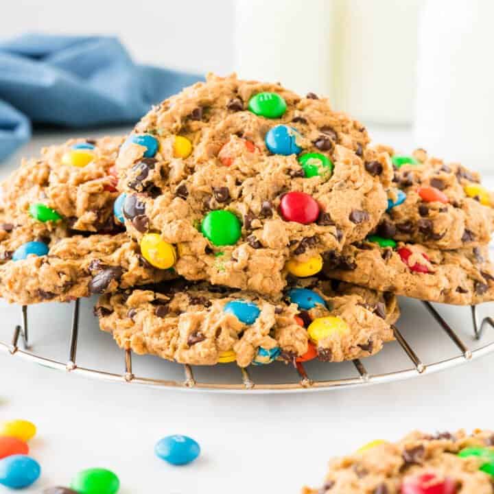 monster cookies stacked on a cooling rack