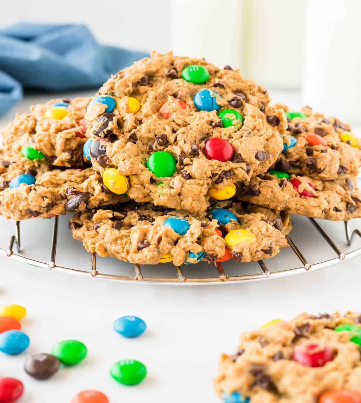 monster cookies stacked on a cooling rack