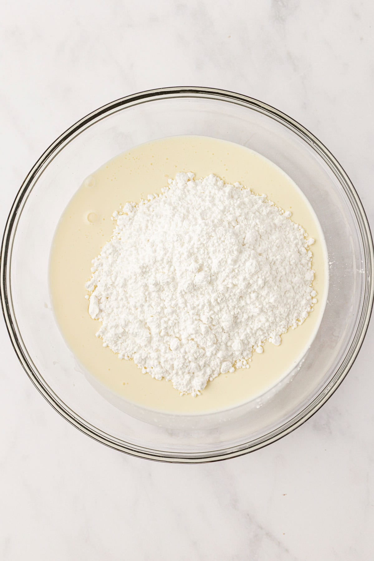 heavy cream and powdered sugar in a mixing bowl