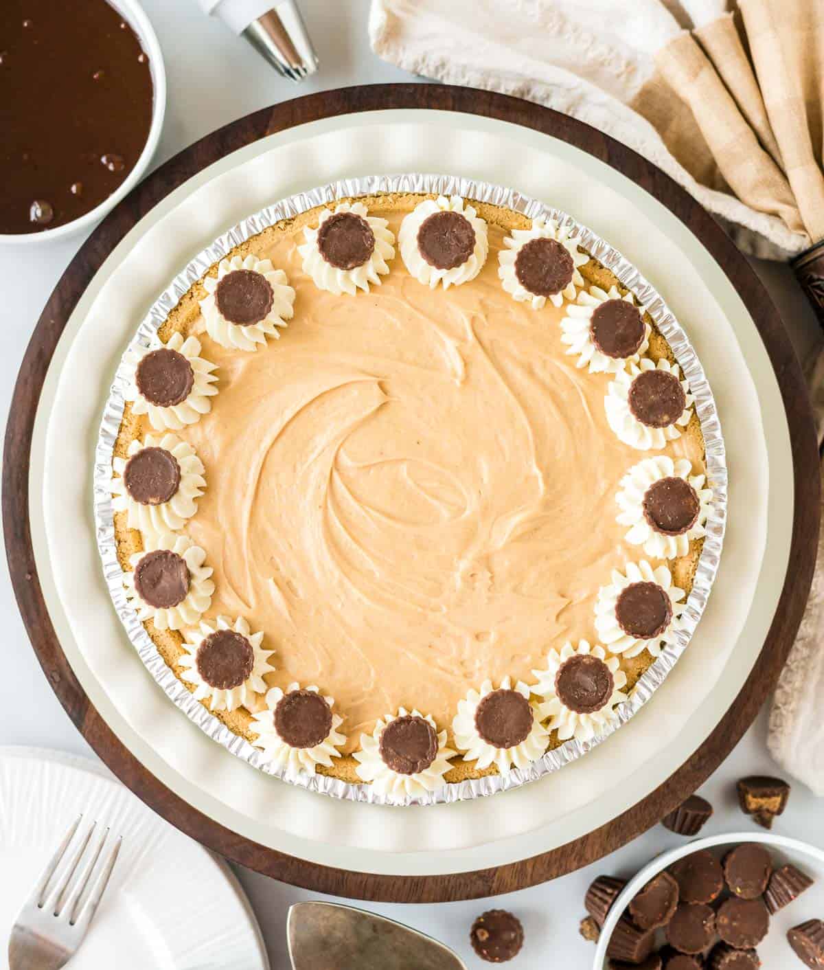 no bake peanut butter pie decorated with whipped cream and resees cups