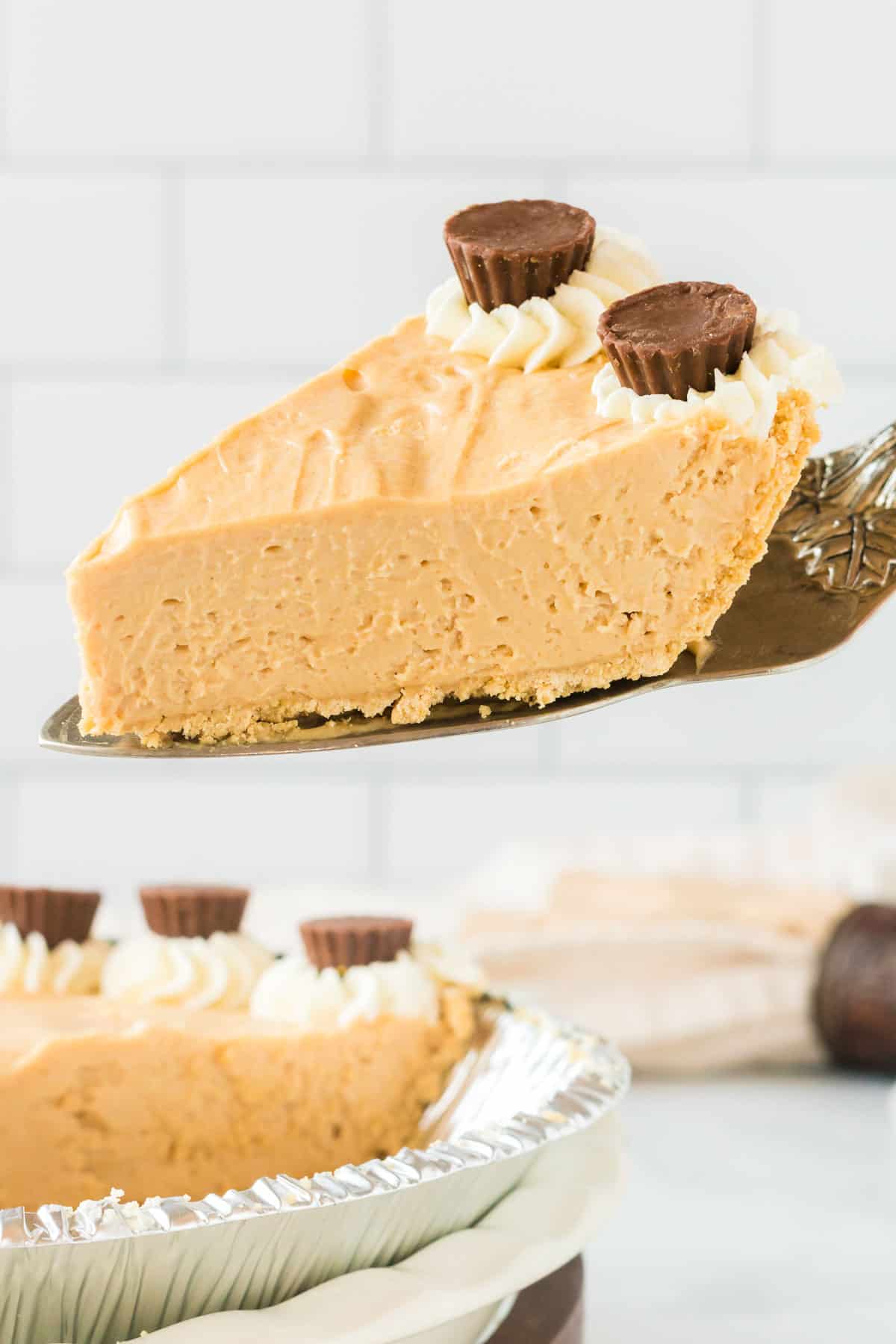 taking a slice of peanut butter pie from the dish