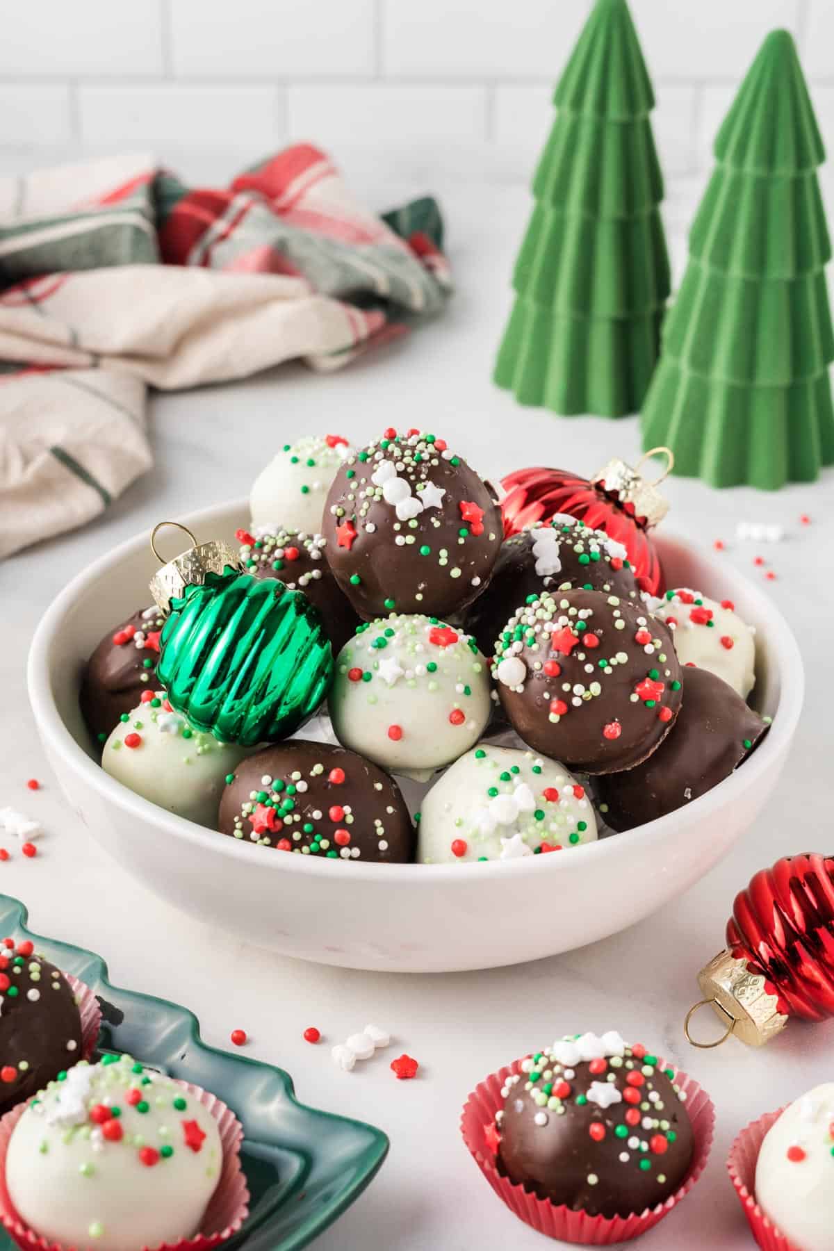 Christmas oreo balls in a bowl with holiday decorations