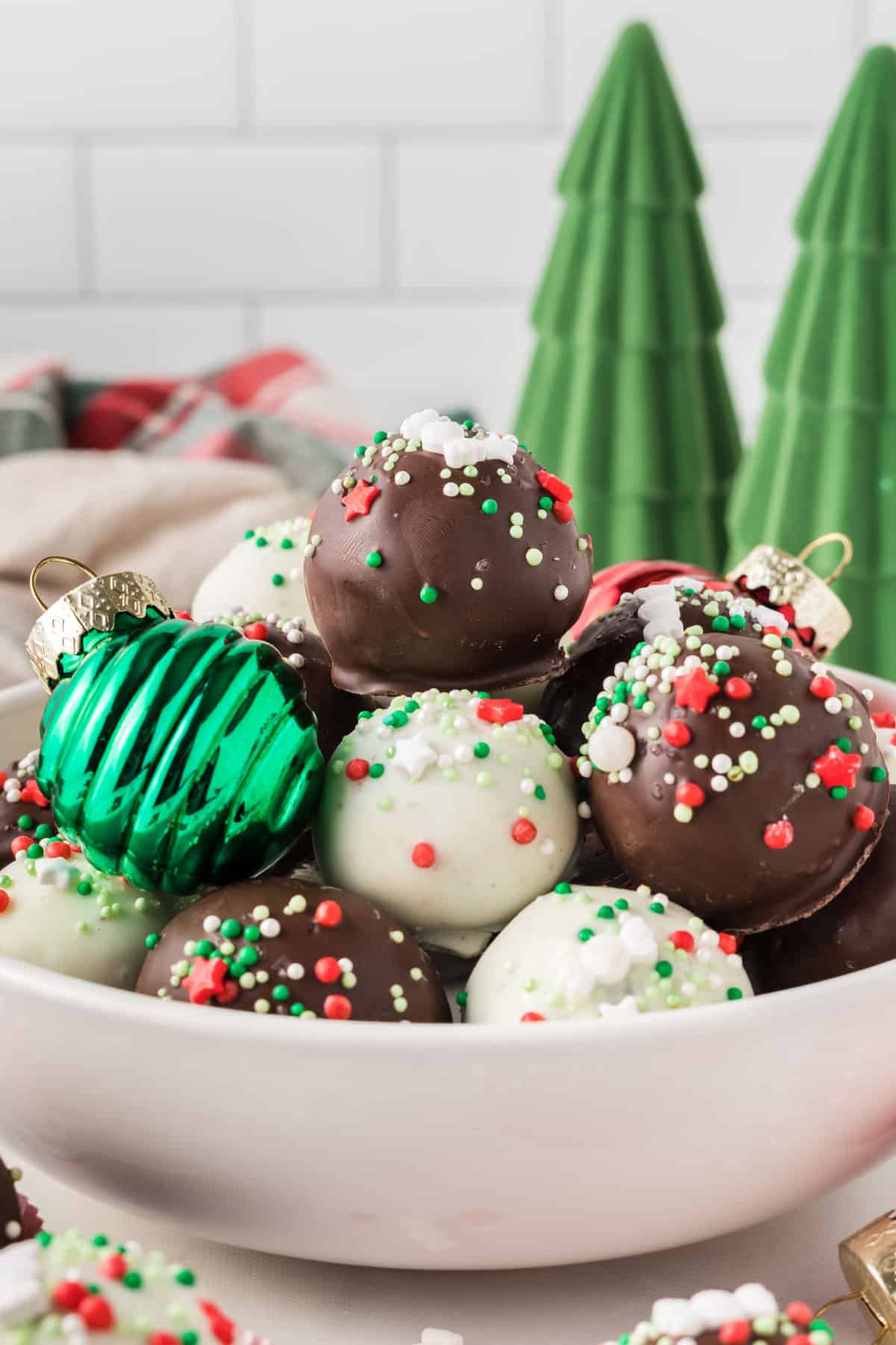 Christmas oreo balls in a bowl with holiday decorations