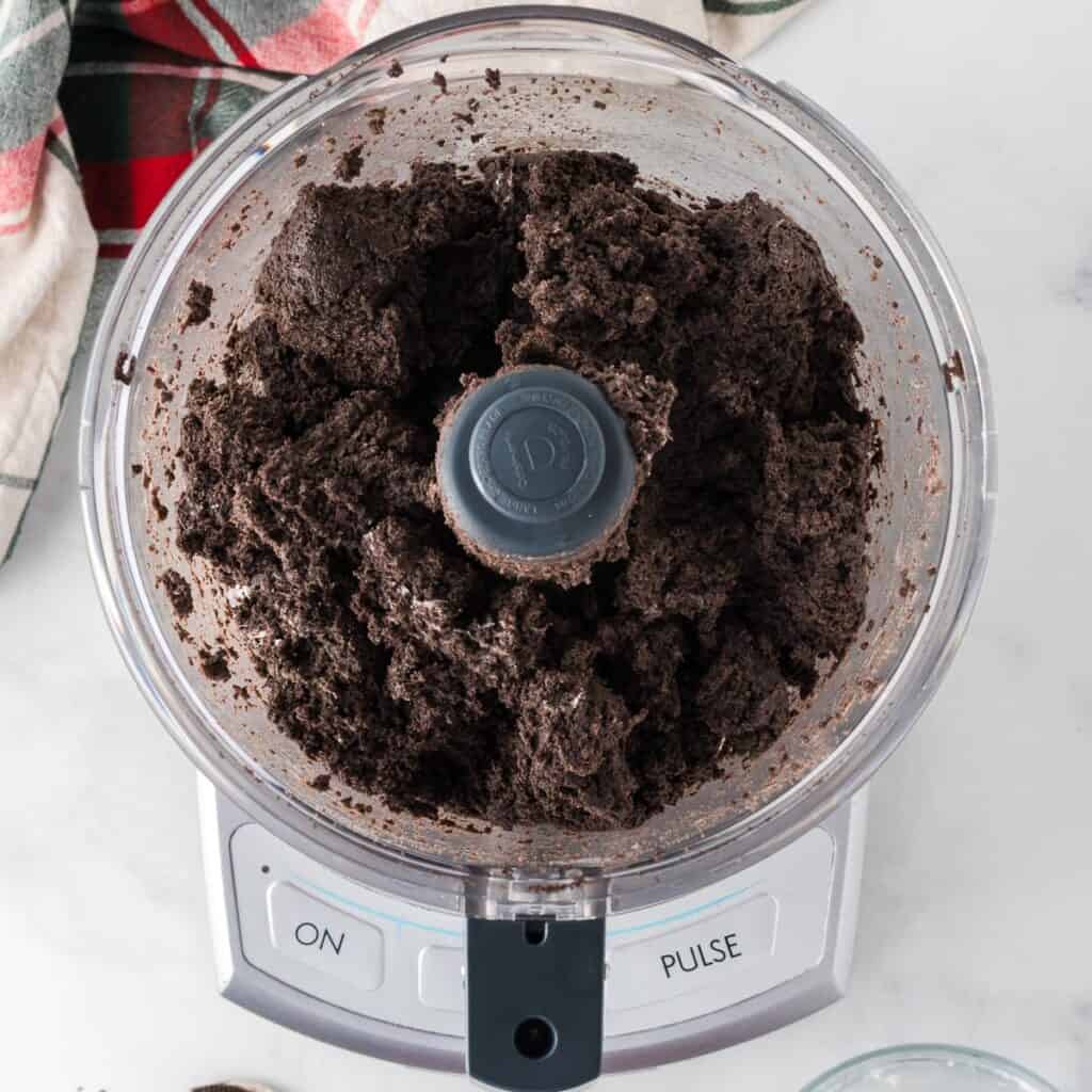 crushed oreos mixed with cream cheese in the food processor