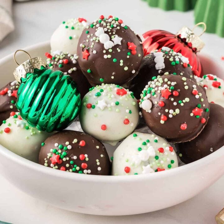 Christmas oreo balls in a bowl with holiday decorations