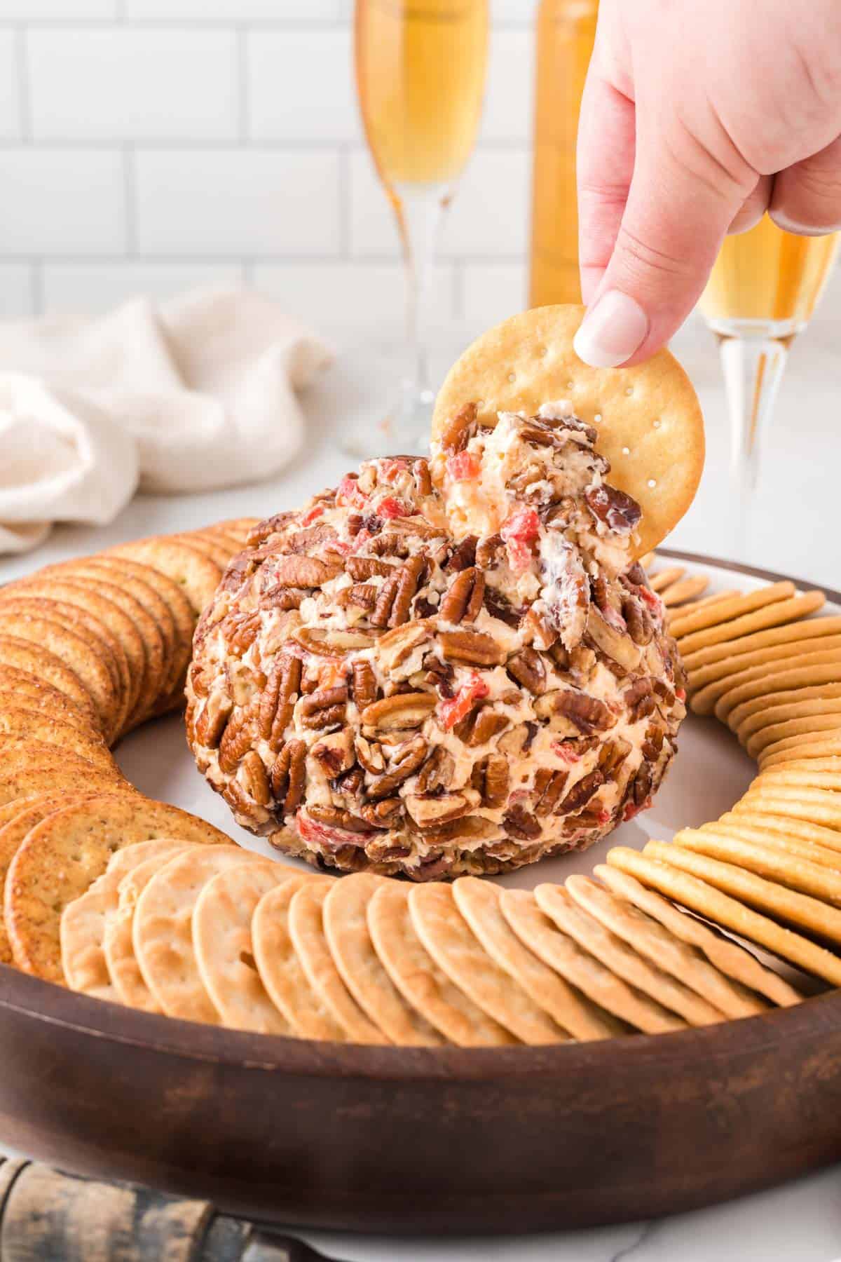 cracker dipping into a cheese ball