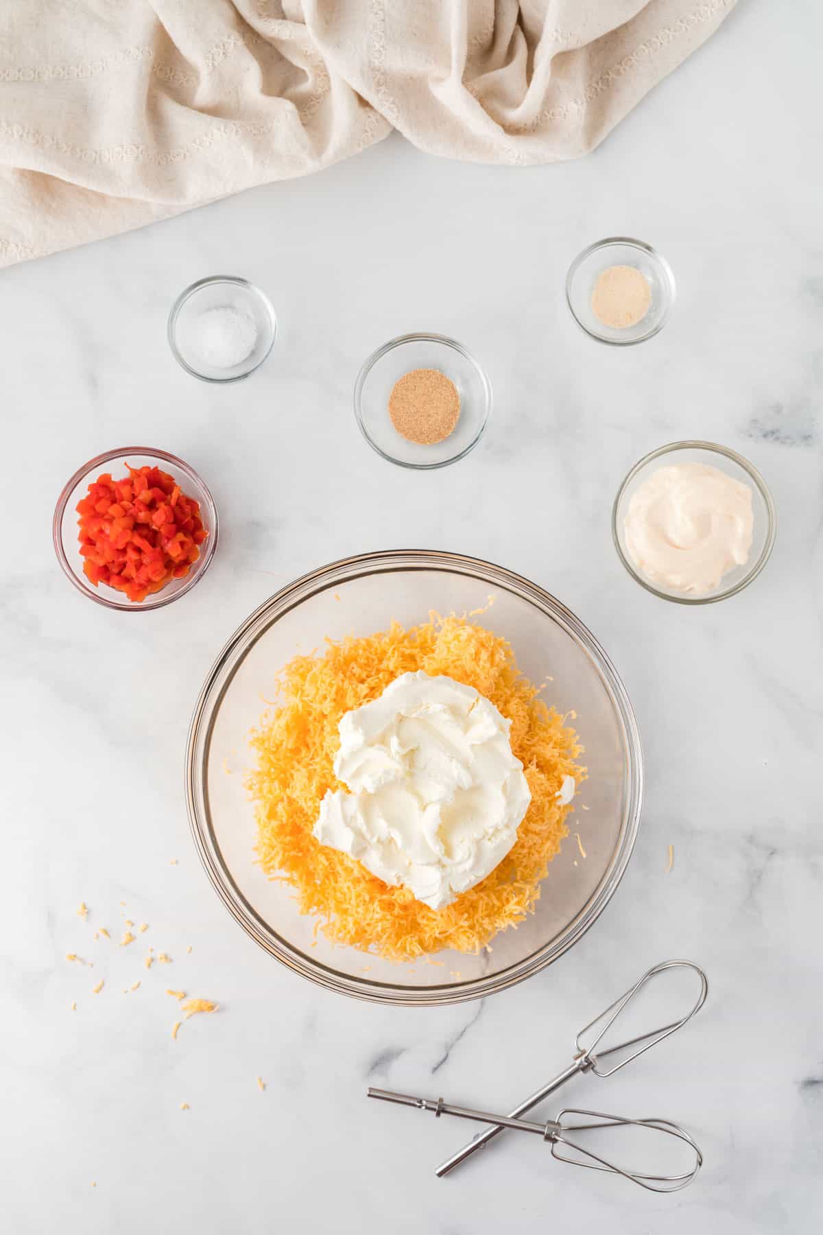 cream cheese and cheddar in a bowl surrounded by the other ingredients