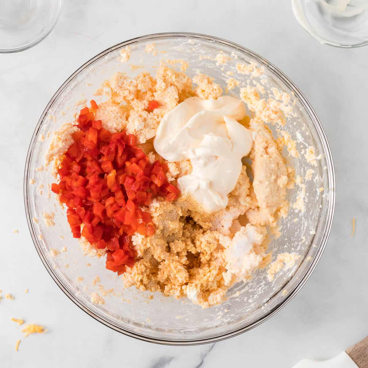 pimentos, mayo, and spices added to the bowl