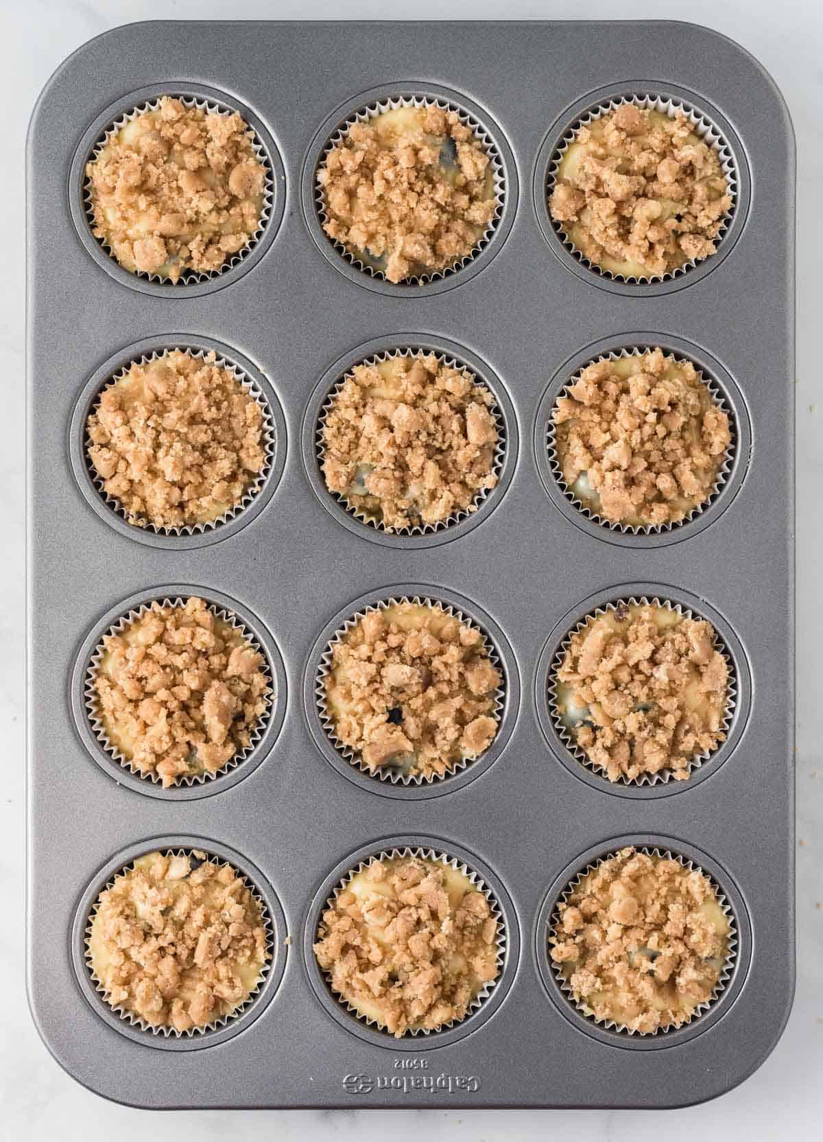 adding the streusel topping to the muffins