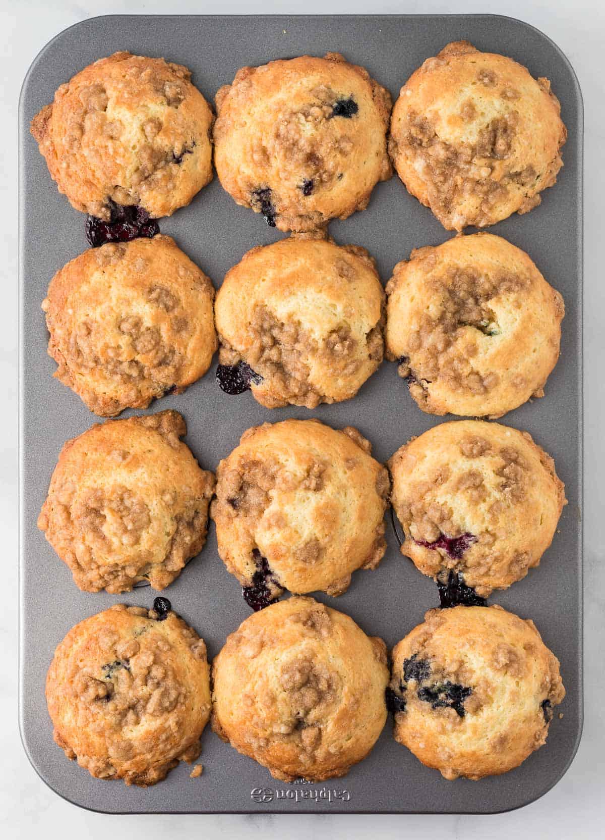 baked blueberry muffins in the muffin tin