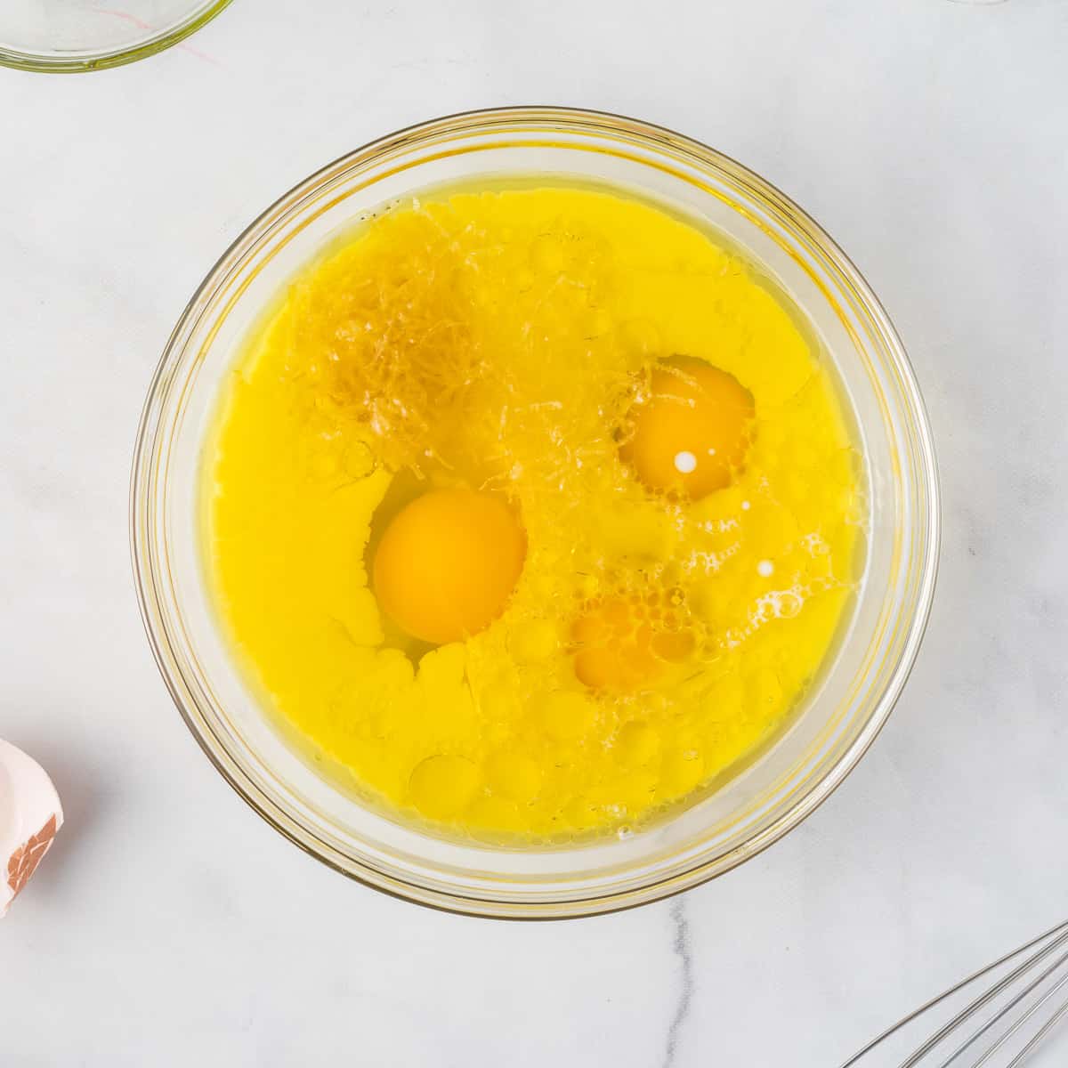 eggs, oil, lemon zest, and milk in a bowl