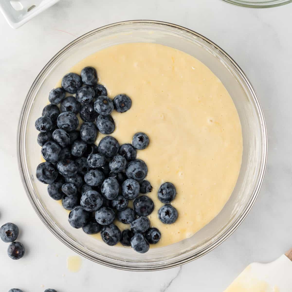 adding the blueberries to the muffin batter