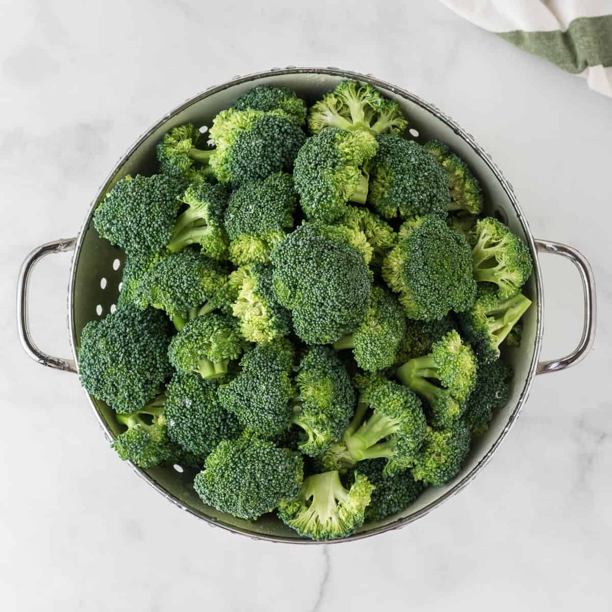 broccoli florets in a strainer