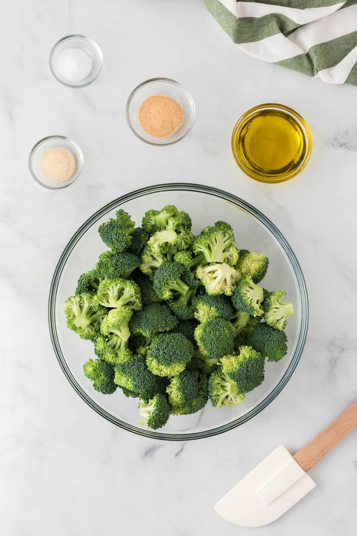 broccoli florets next to oil and spices