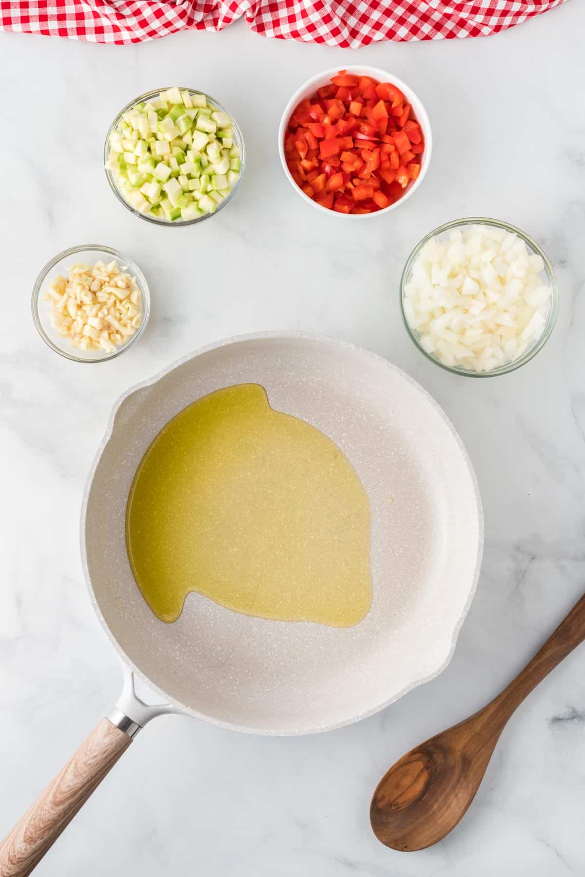 oil in a skillet surrounded with the chopped up vegetables