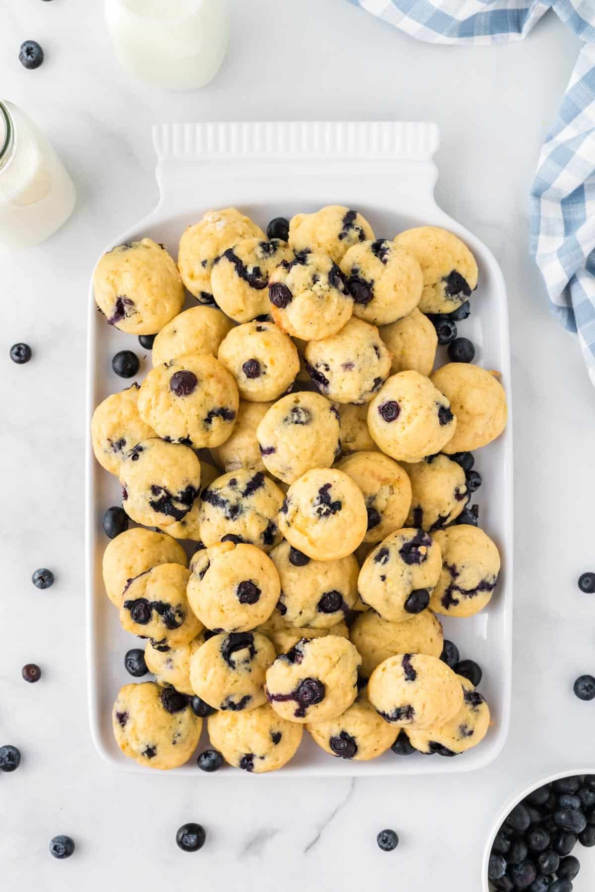 blueberry mini muffins on a white serving tray