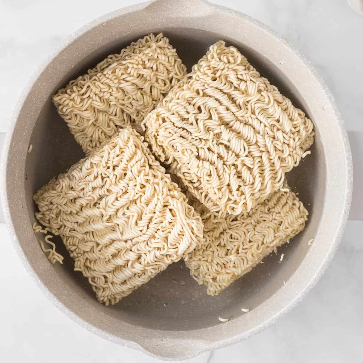 ramen noodle blocks in a sauce pan