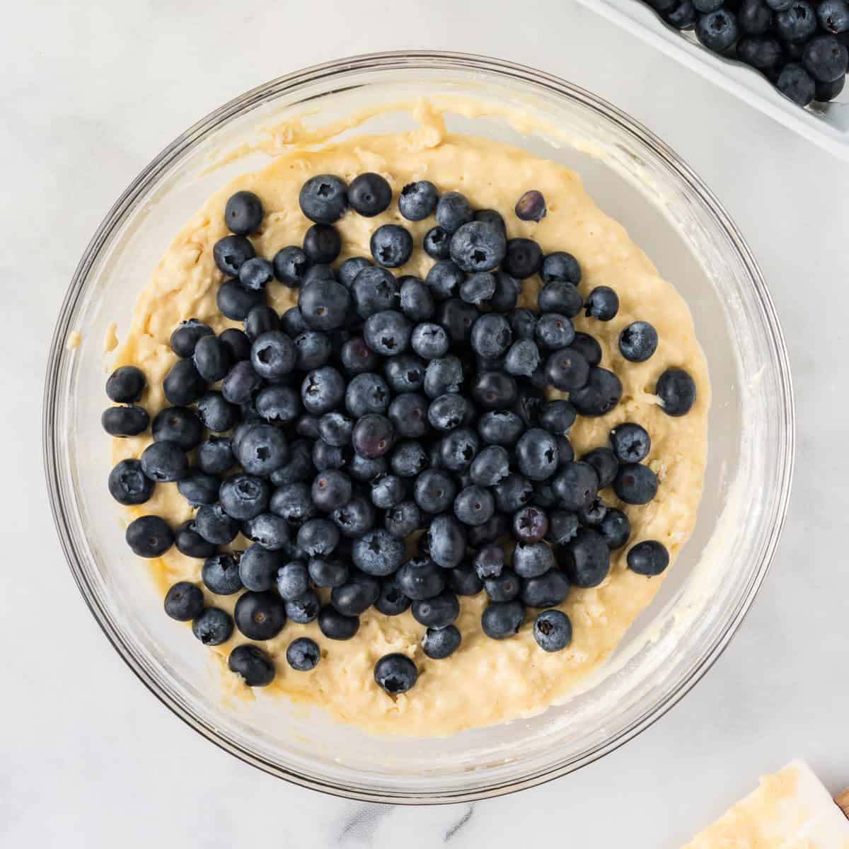 adding the blueberries to the muffin batter