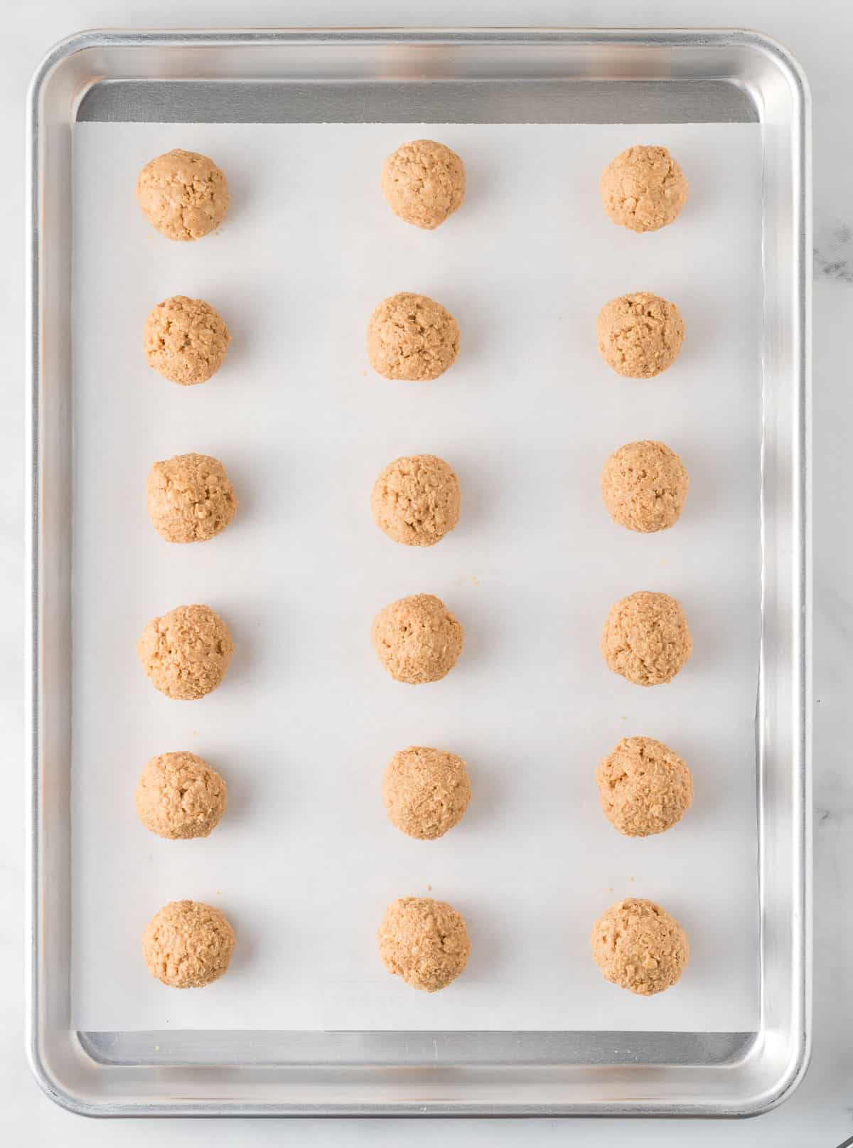 peanut butter rice krispies balls on a baking sheet
