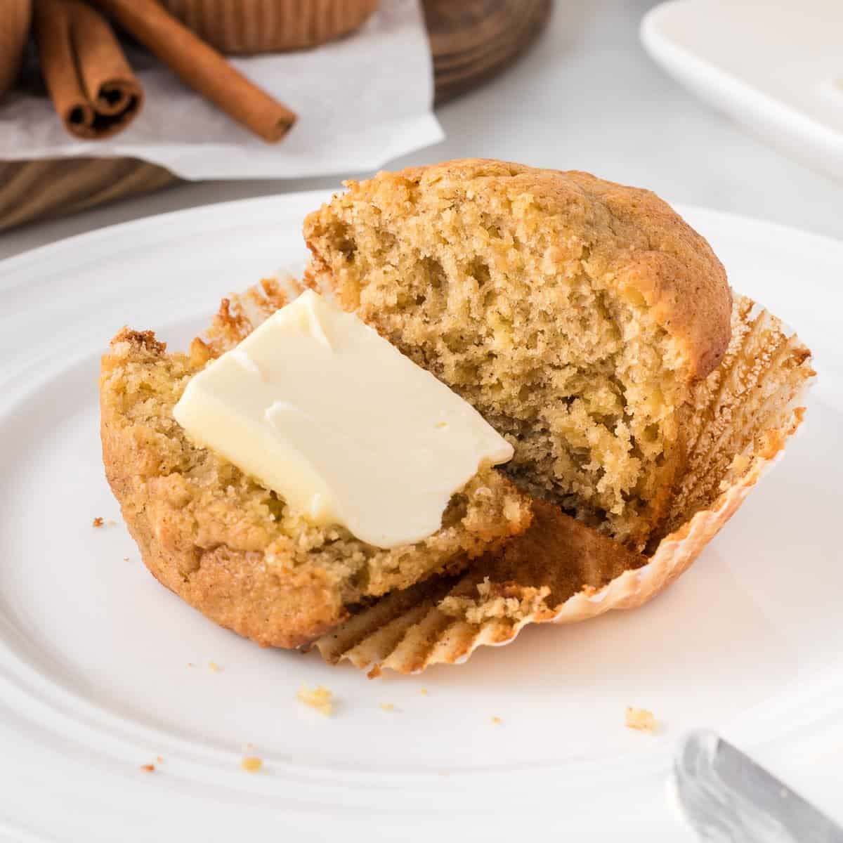 banana muffin cut in half with butter on one side