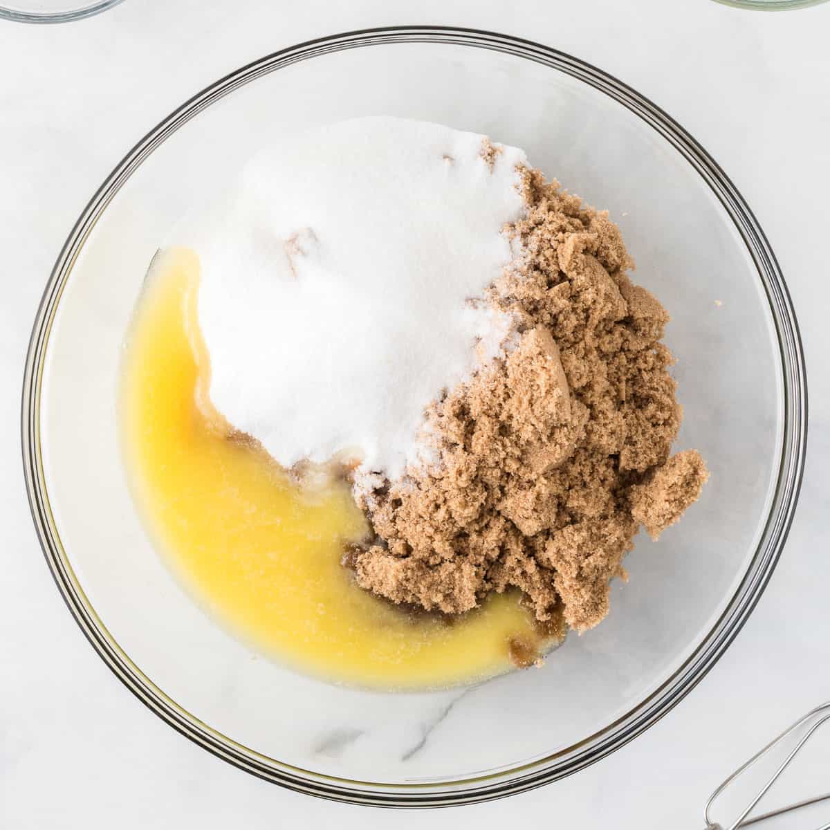 adding the butter and sugars to a bowl