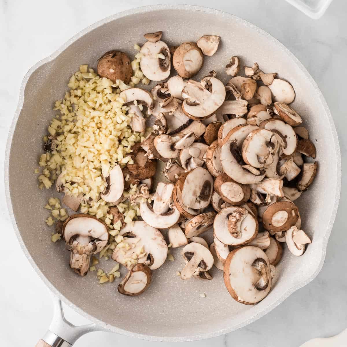 mushrooms and minced garlic in a skillet