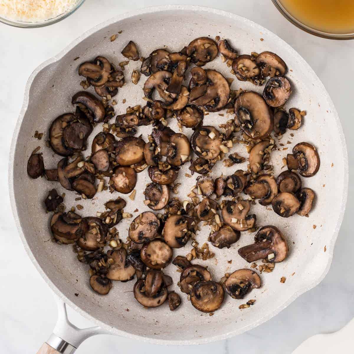 cooked down mushrooms and garlic in a skillet