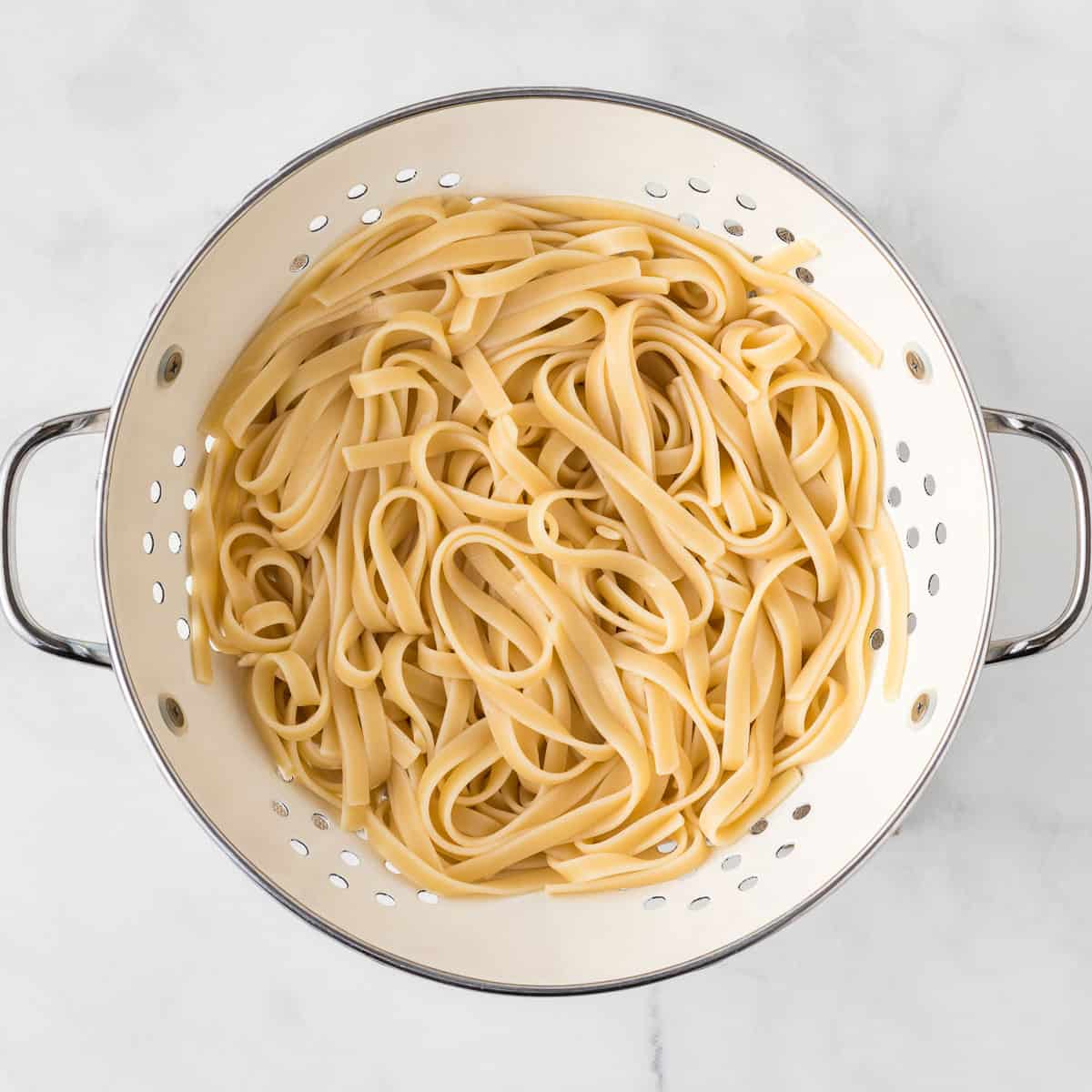 cooked fettuccini in a strainer