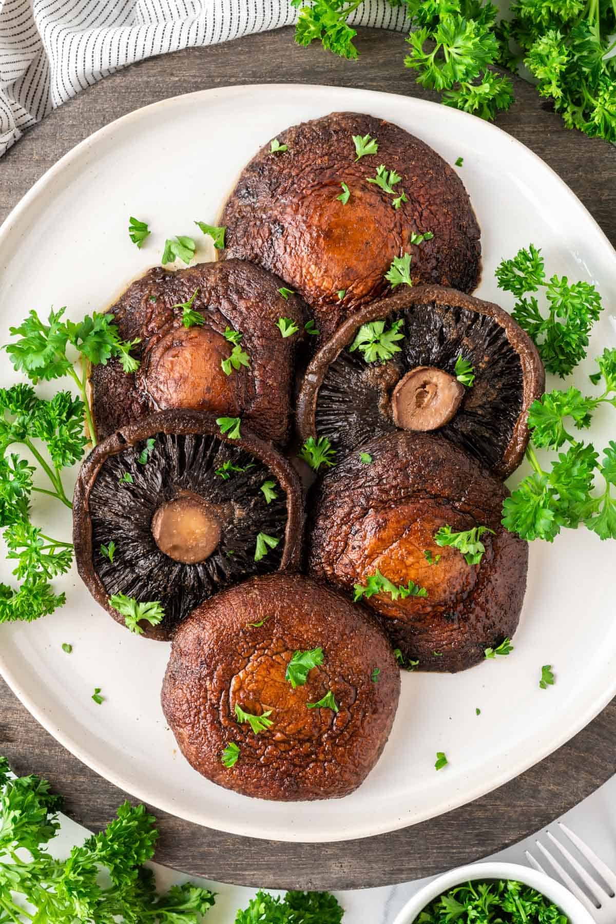 portobello mushrooms topped with parsley on a plate