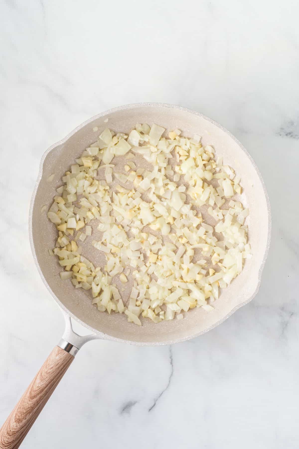 garlic and onion cooked down in a skillet