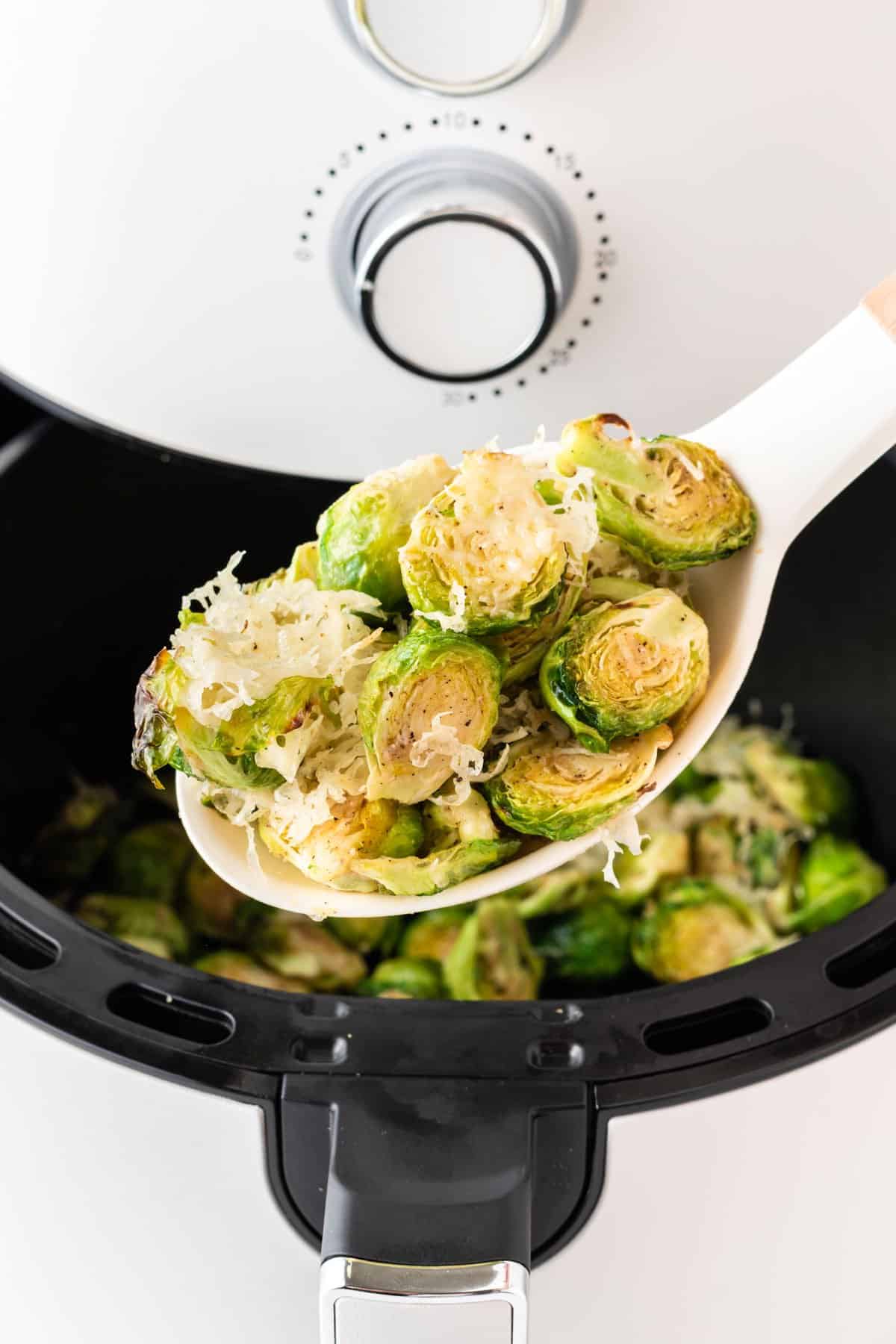 spoon holding a scoop of cheesy brussels sprouts