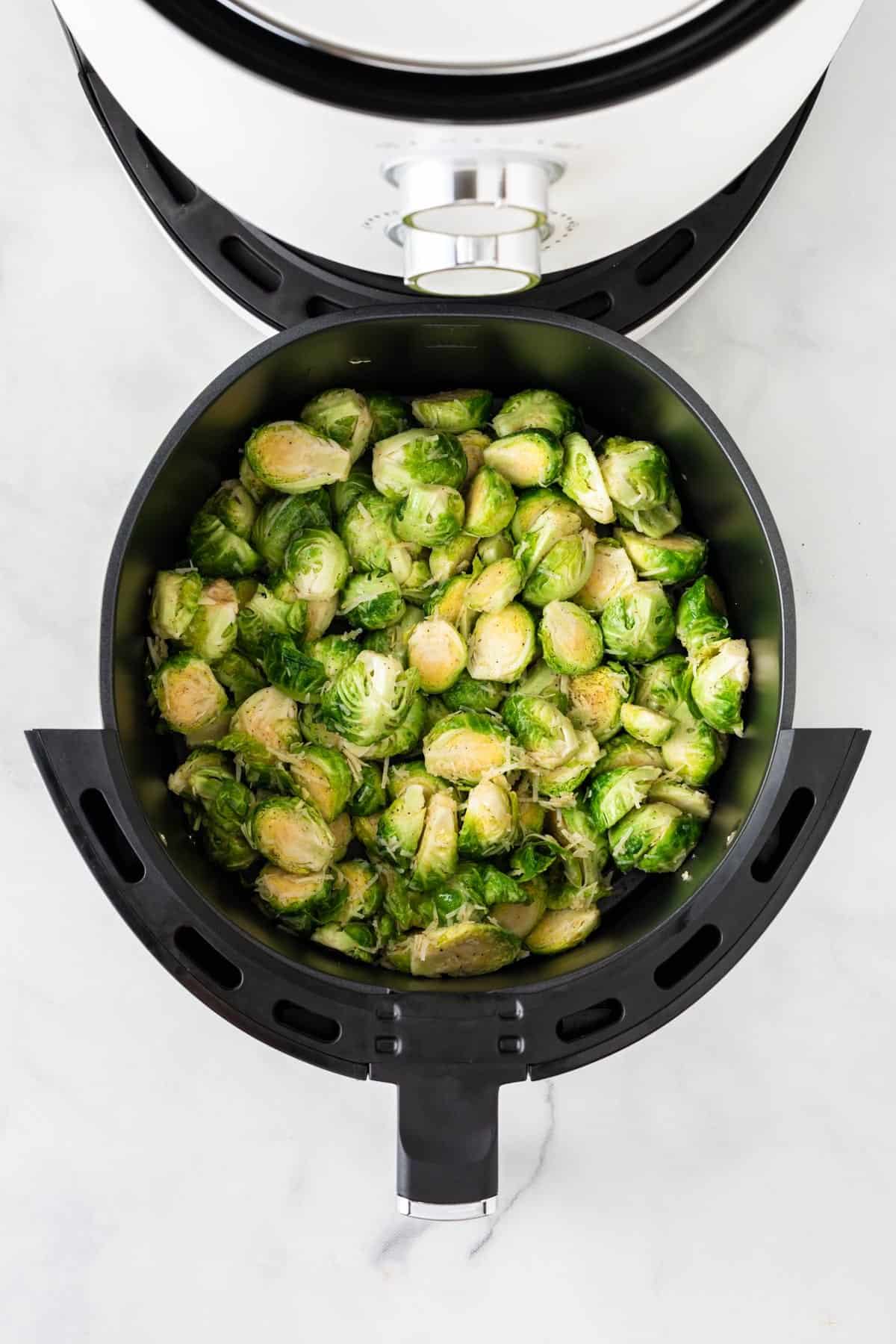 placing the brussels into the air fryer basket