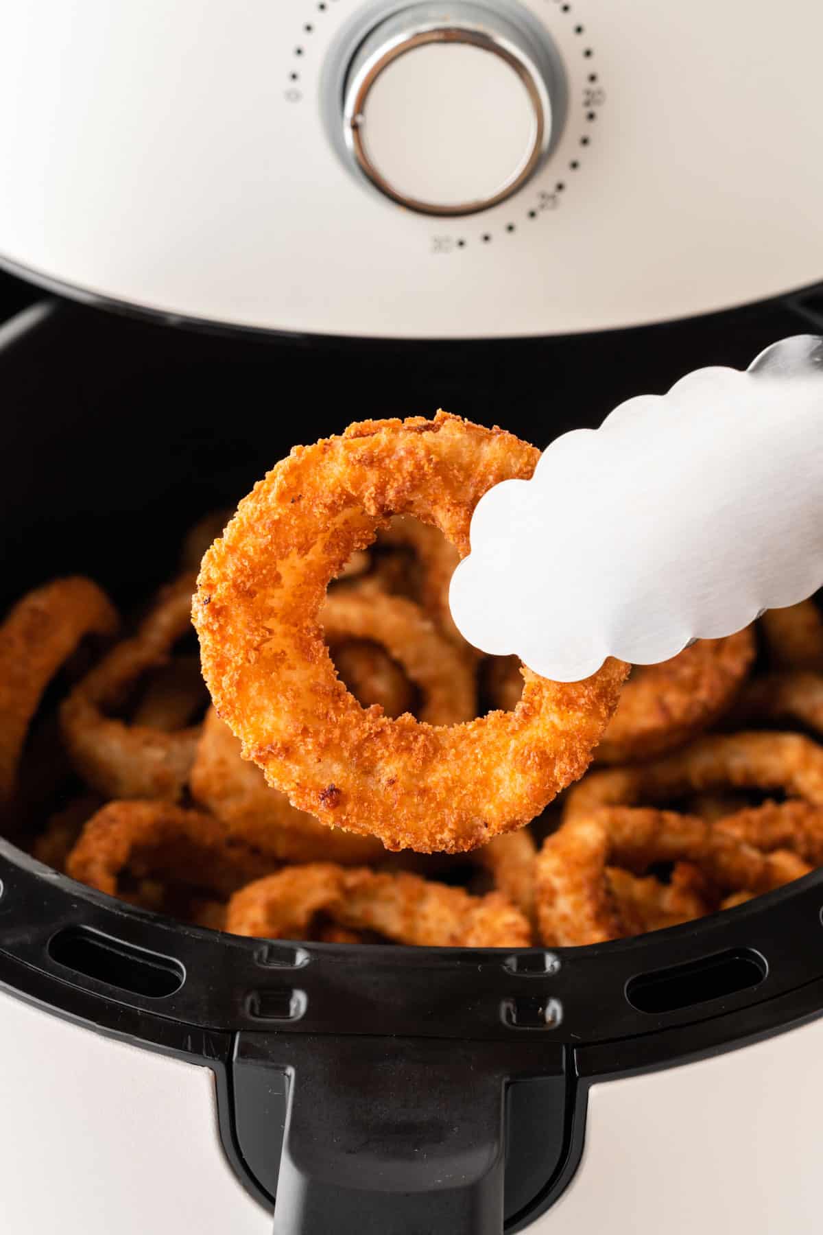taking an onion ring from the air fryer