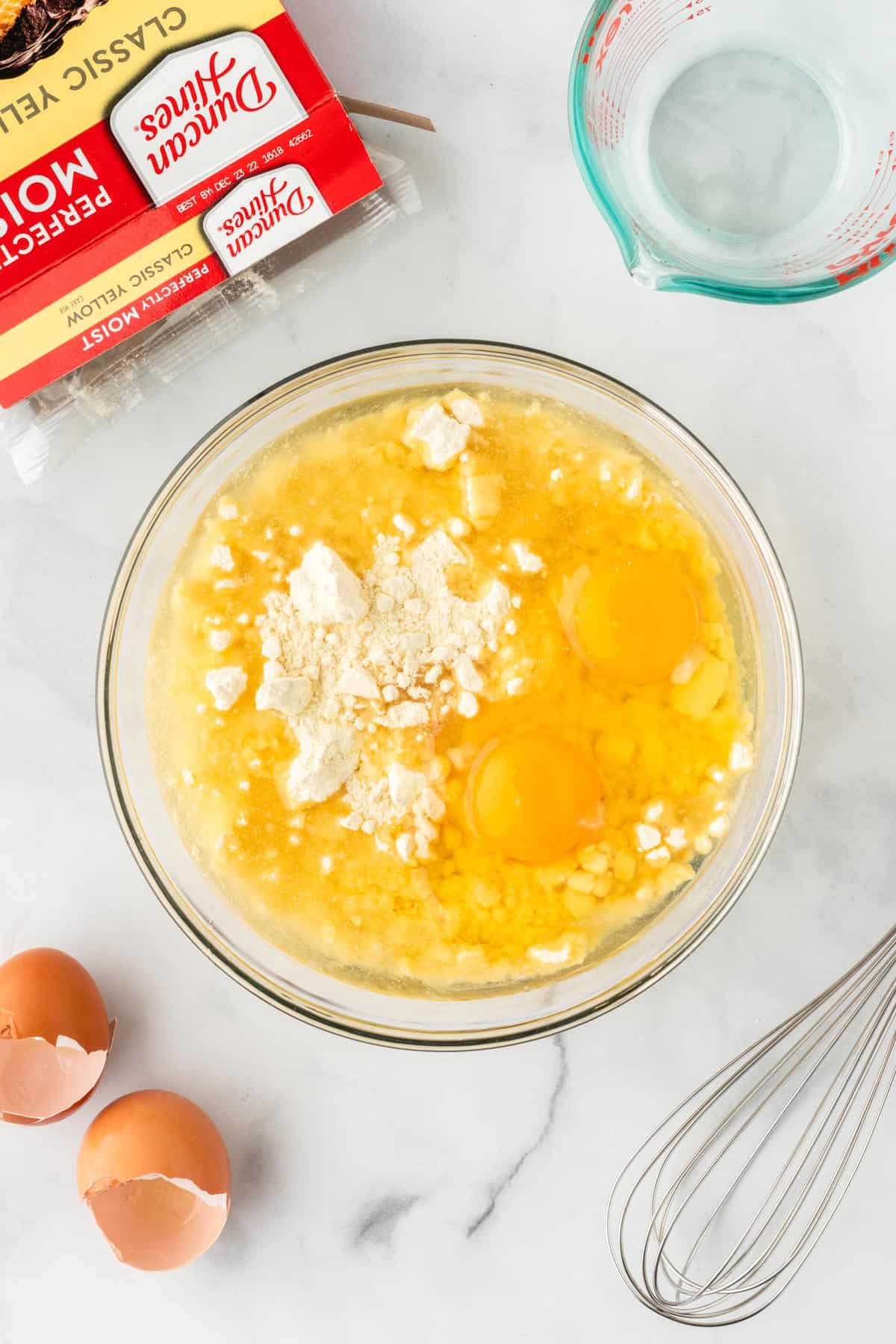 adding oil and eggs to the cake mix