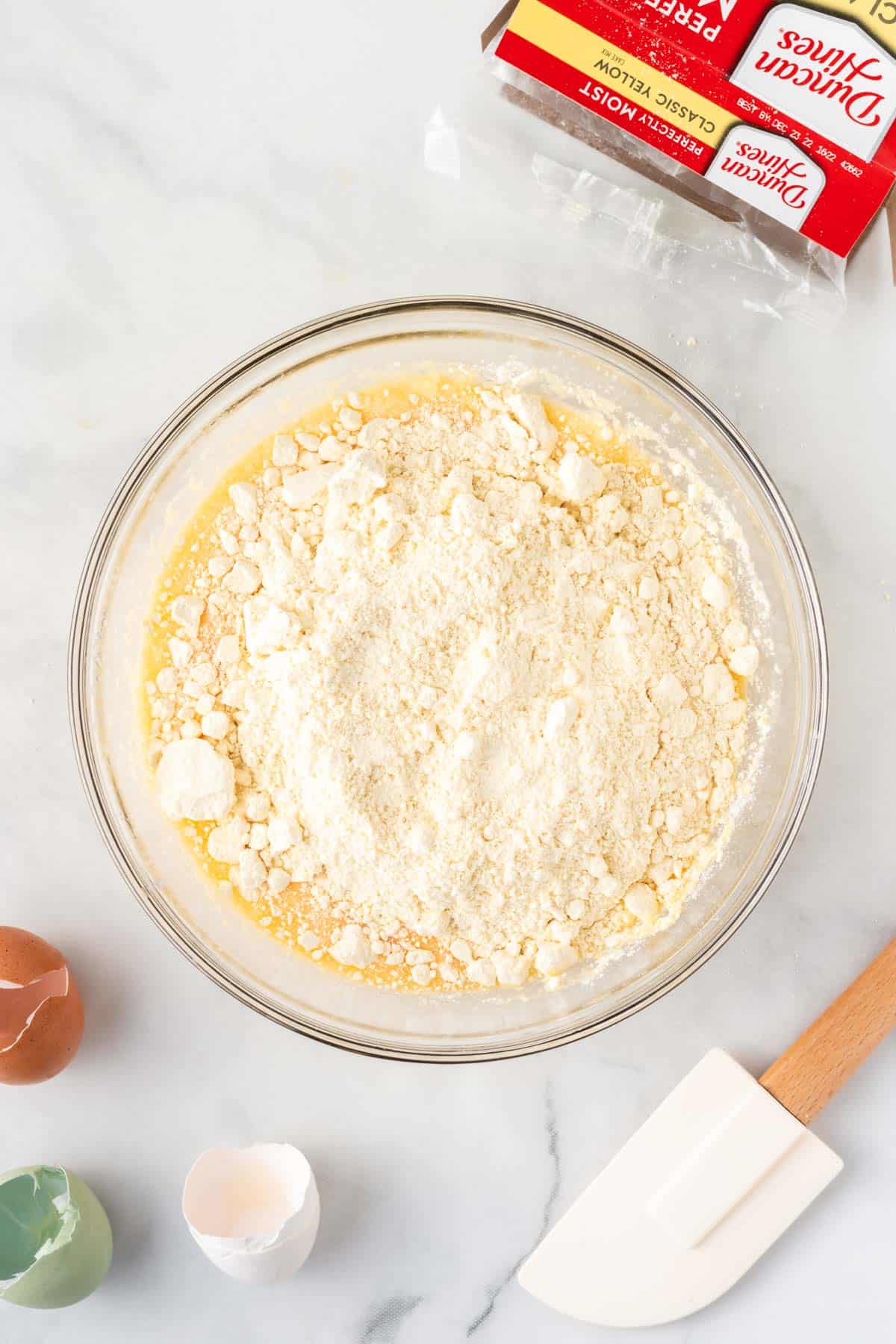 adding the cake mix to the wet ingredients