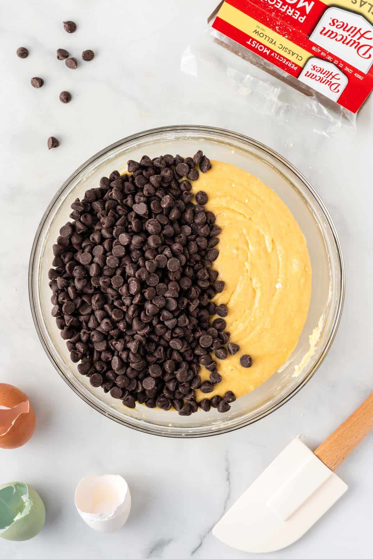 adding the chocolate chips to the muffin batter