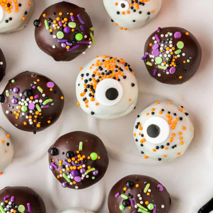 halloween decorated oreo balls on a plate