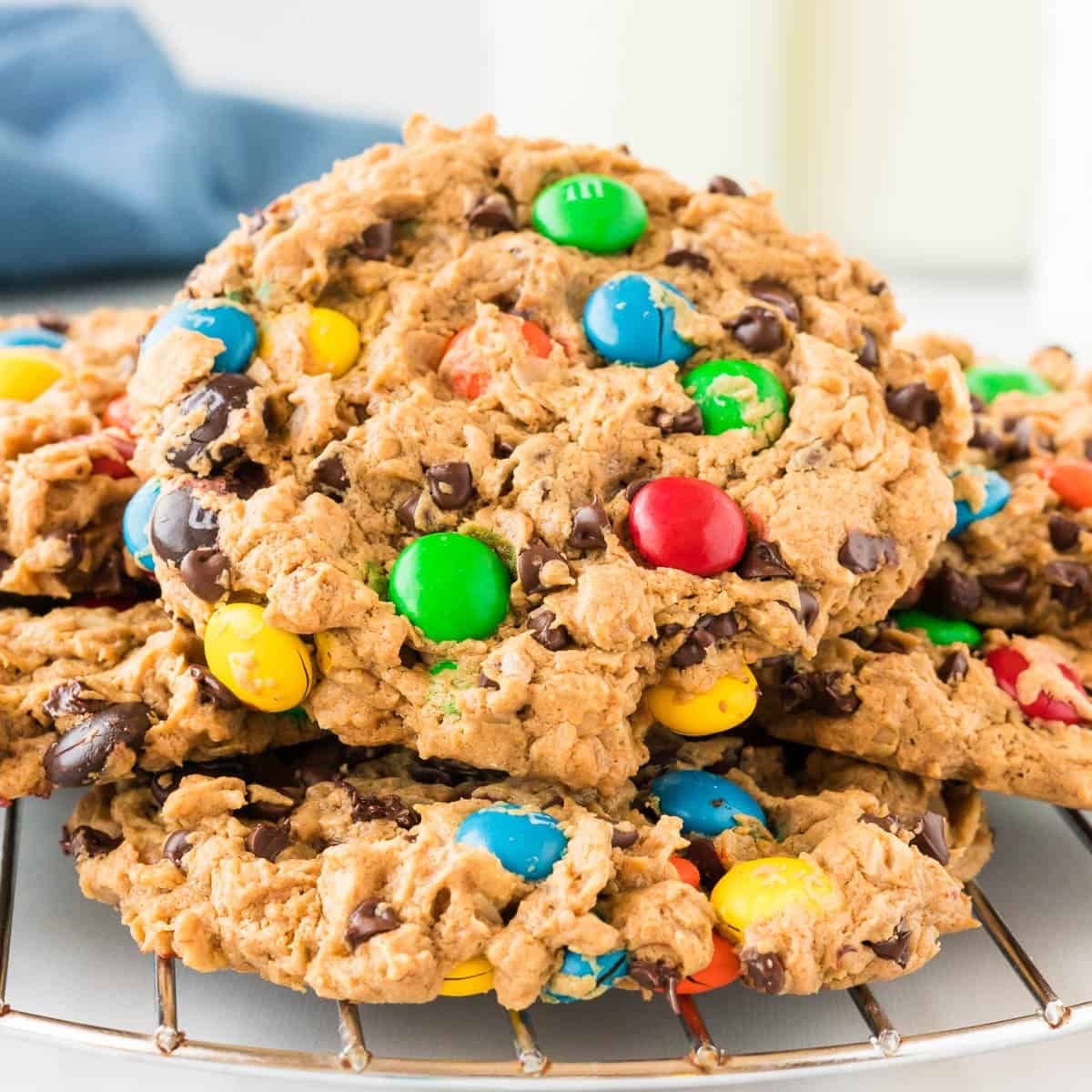 monster cookies stacked on a cooling rack