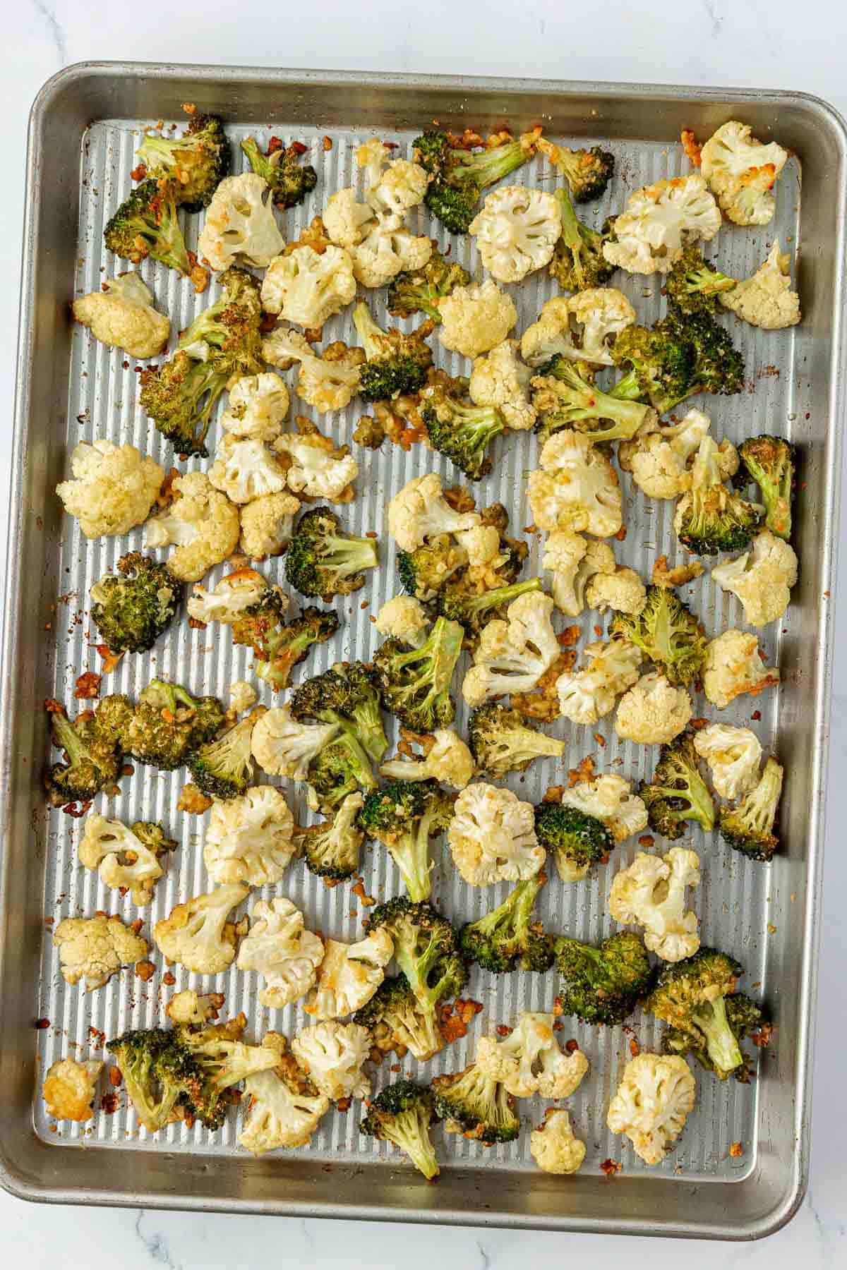 roasted broccoli and cauliflower on a baking sheet