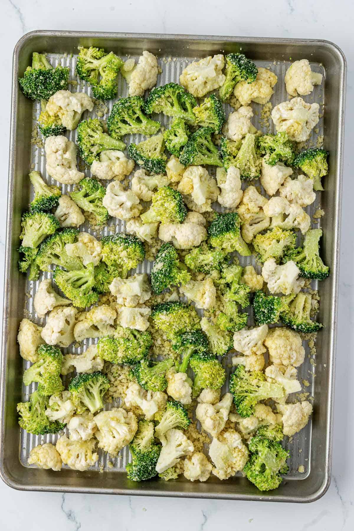 broccoli and cauliflower on a baking sheet
