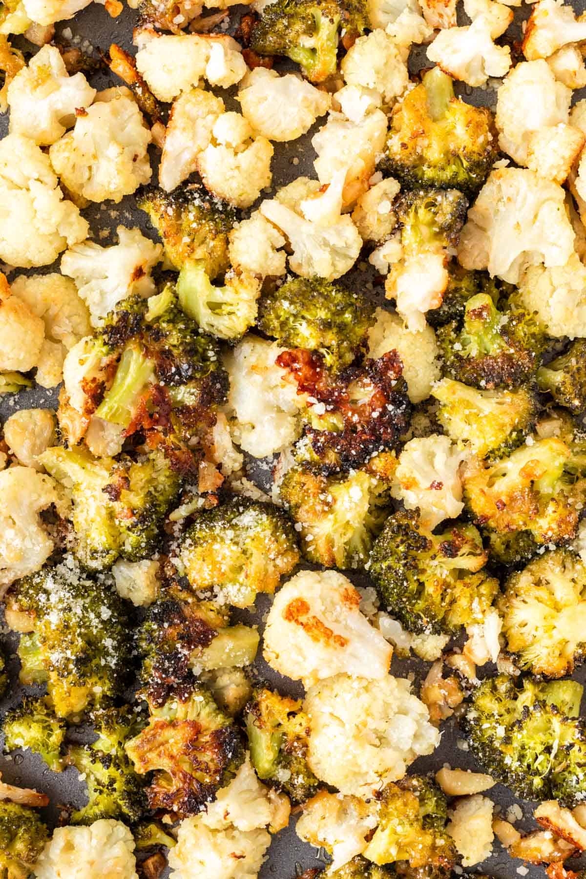 roasted broccoli and cauliflower on a baking sheet
