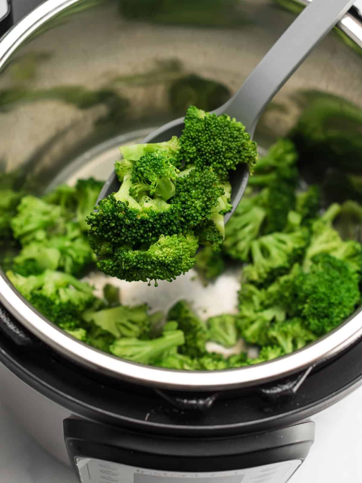 spoon scooping broccoli from the instant pot