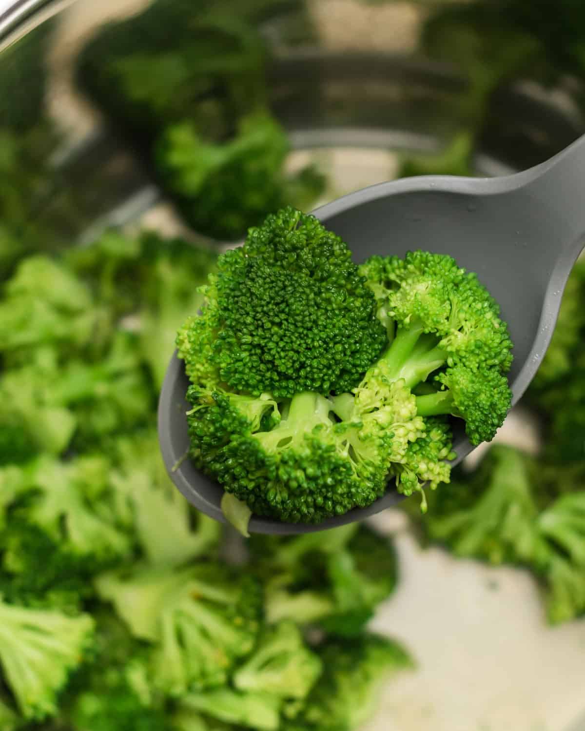 spoon scooping broccoli from the instant pot