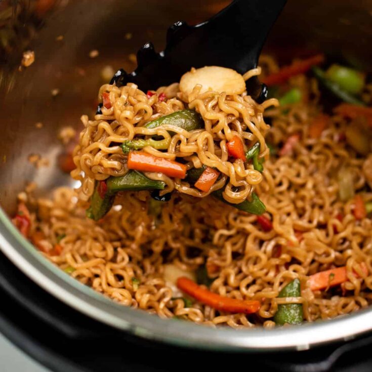 taking a scoop of stir fry noodles from the instant pot