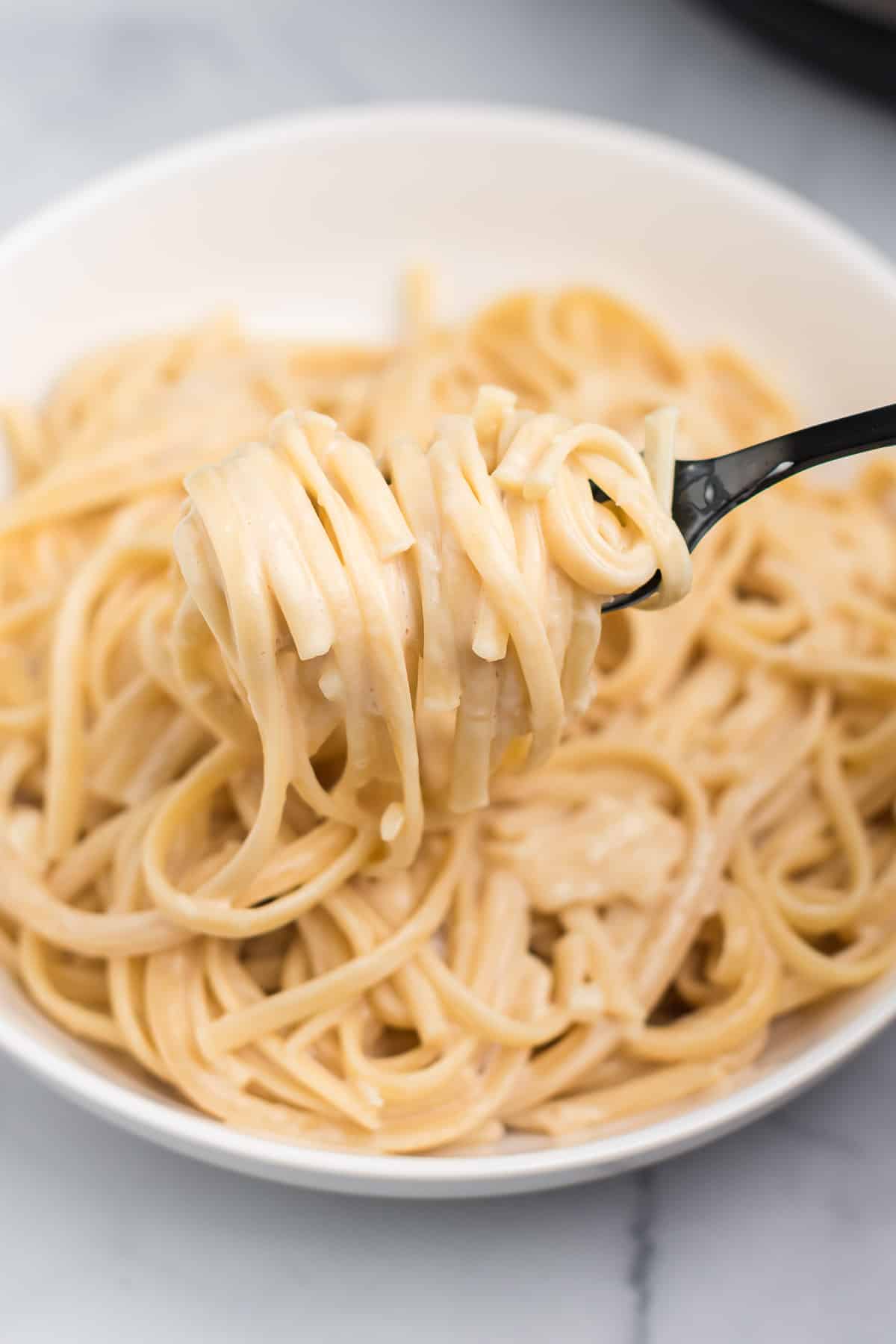 instant pot creamy pasta twirled on a fork