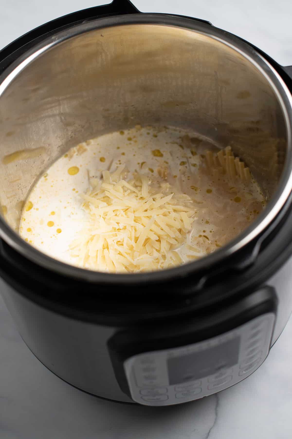 adding the heavy cream and cheese to the instant pot