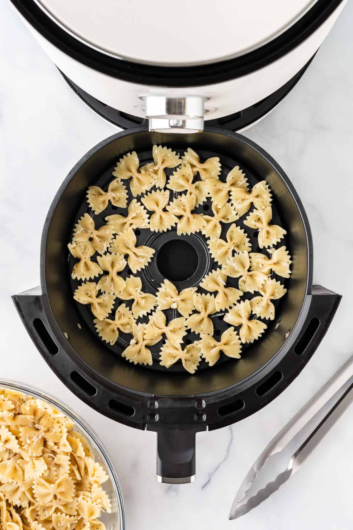 pasta in the air fryer basket in one layer