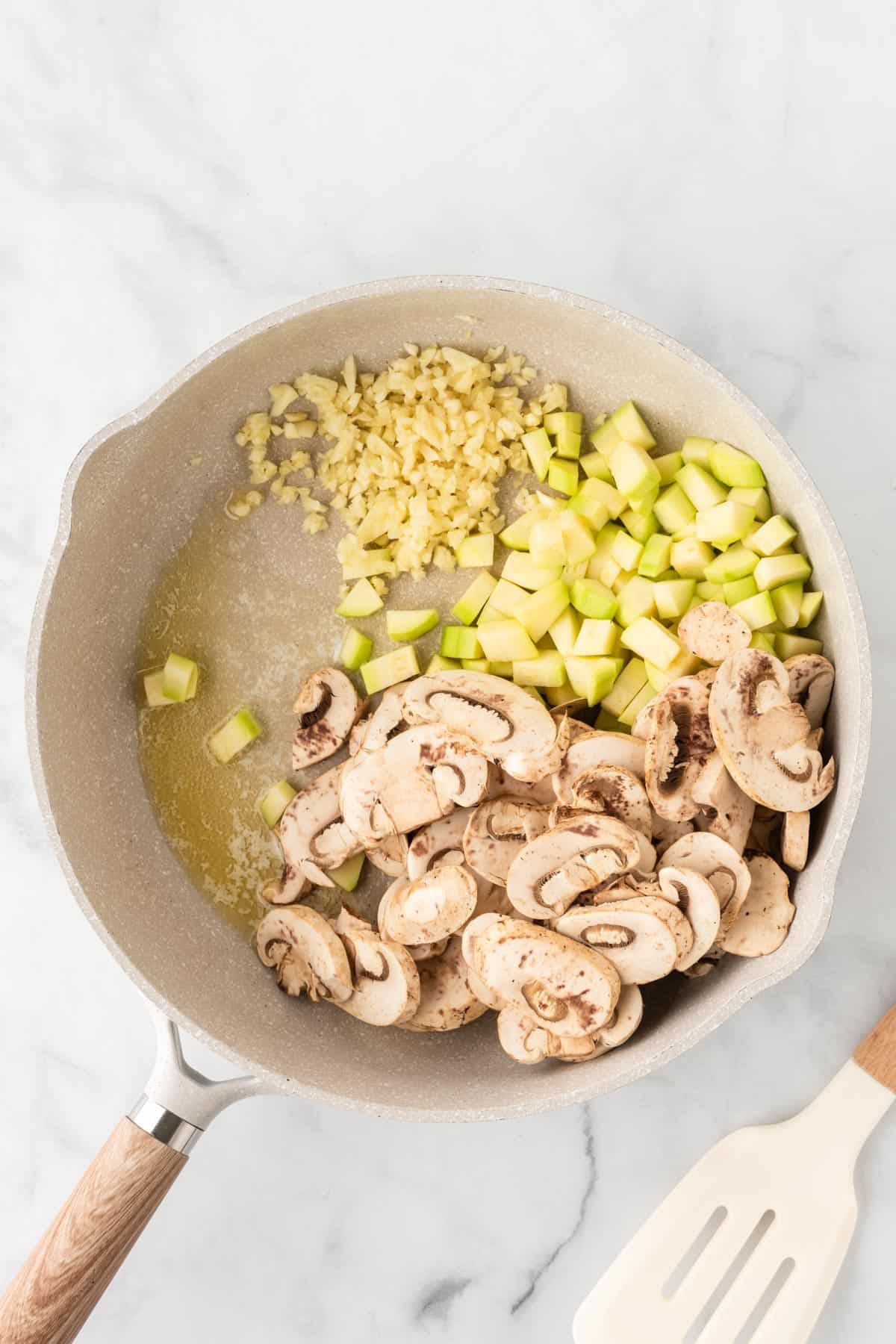 mushrooms, garlic, and zucchini in a skillet