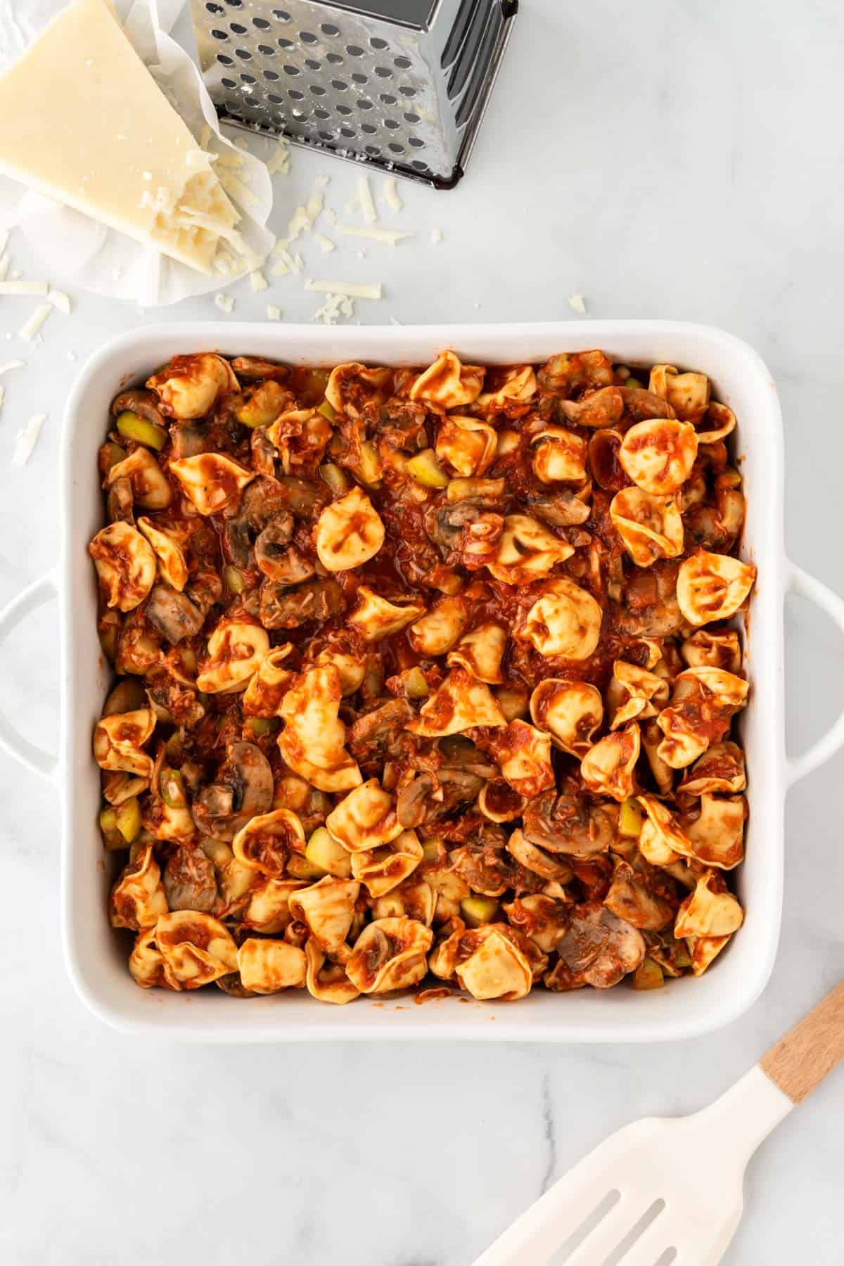 adding the filling to a baking dish