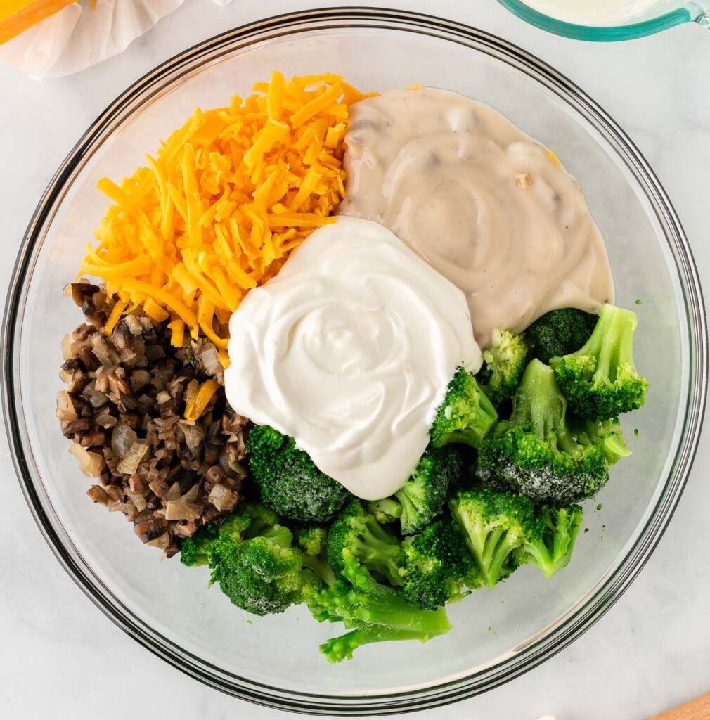 broccoli casserole ingredients in a mixing bowl